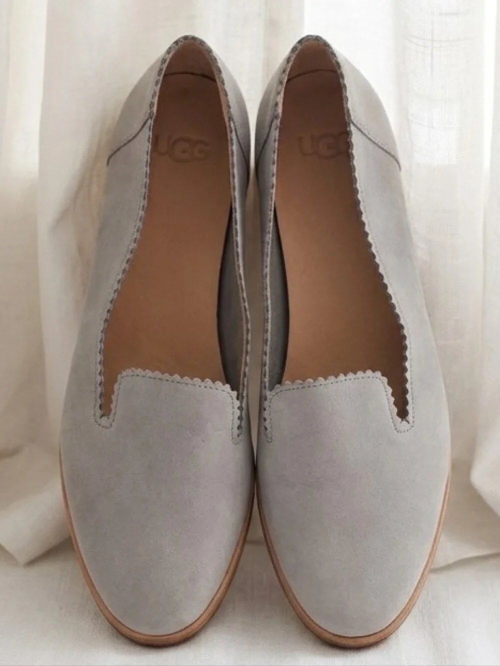 UGG Vista slip-on flats featuring a distinct scalloped edge detail.
